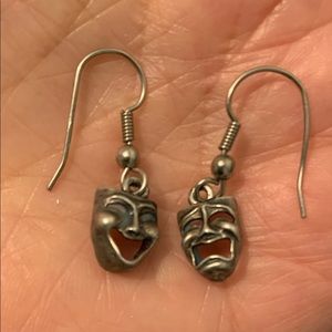 Theatrical mask earrings. I believe silver but not sure. If you like drama, buy!